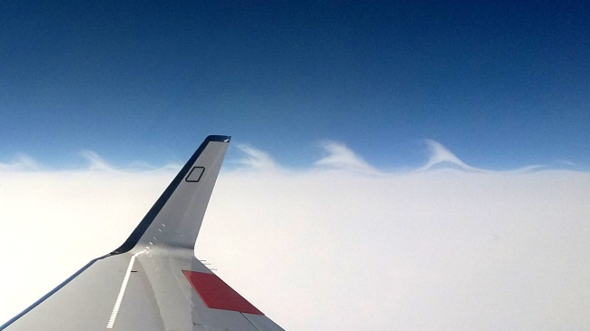 Kelvin-Helmholtz instabilities rendered visible by clouds during a flight above a warm conveyor belt during the WISE (Wave-driven ISentropic Exchange) campaign. The wave structure indicates mixing processes at the tropopause that redistribute water vapour and ice particles. (Photo: Peter Hoor)